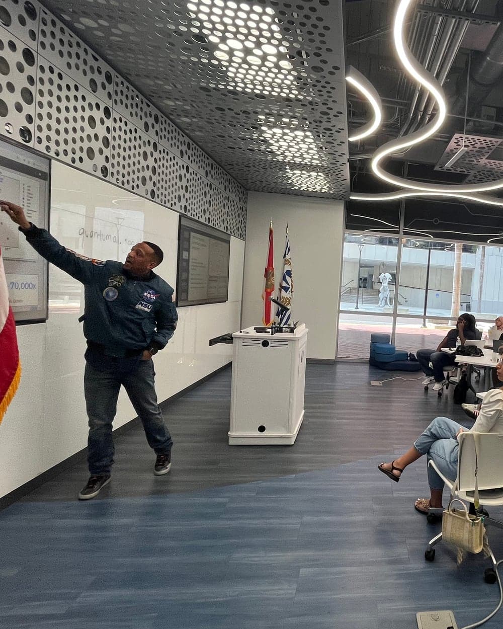 A presenter teaching quantum to a room of adults