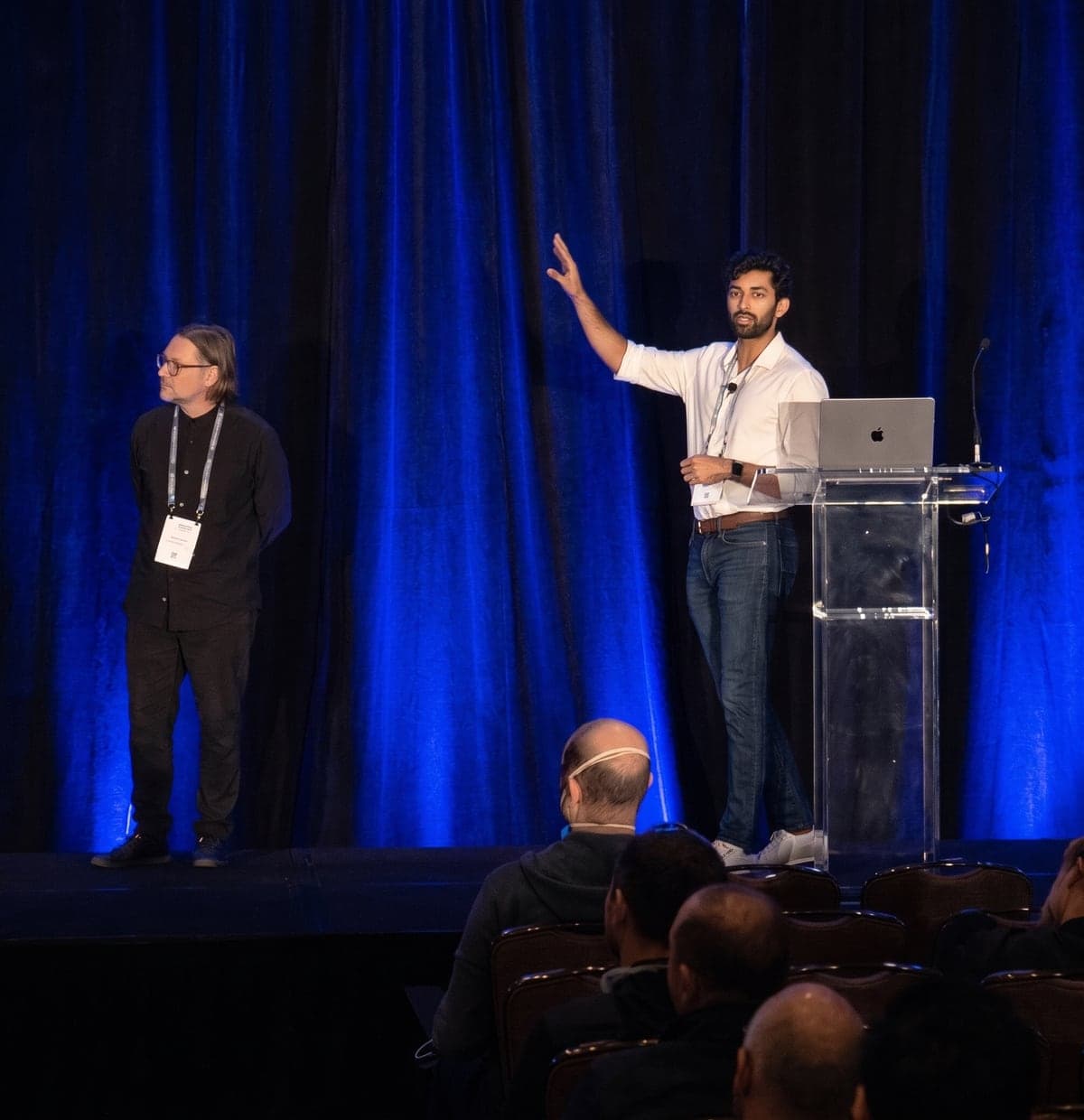 Sohum Thakkar speaking on stage to an audience at the Q2B quantum conference