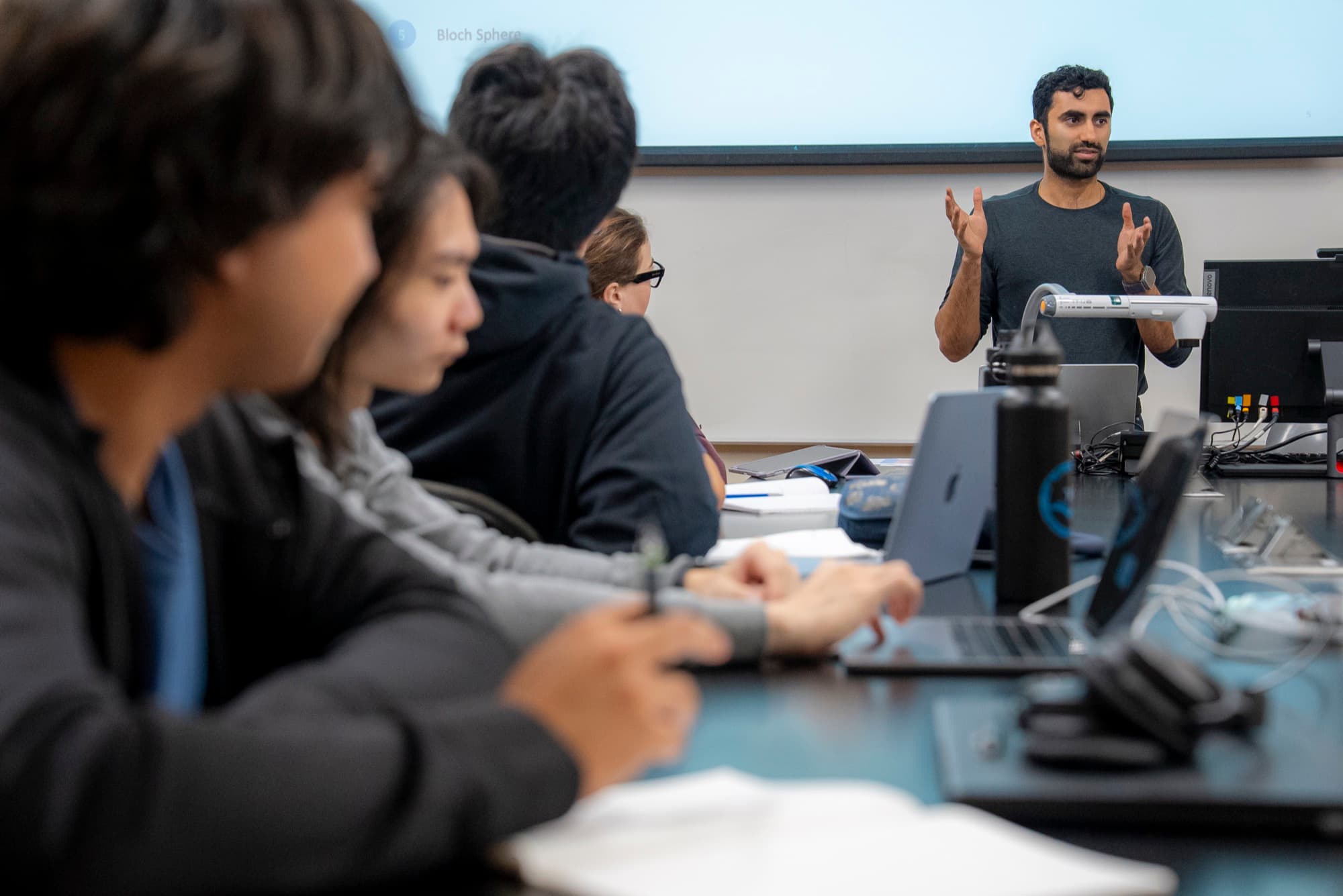 Sohum Thakkar teaching BERQ students, who hold Qubis at their benches