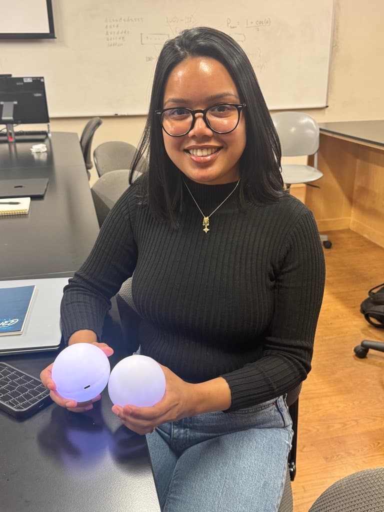 Umaima Raisa holding two Qubis