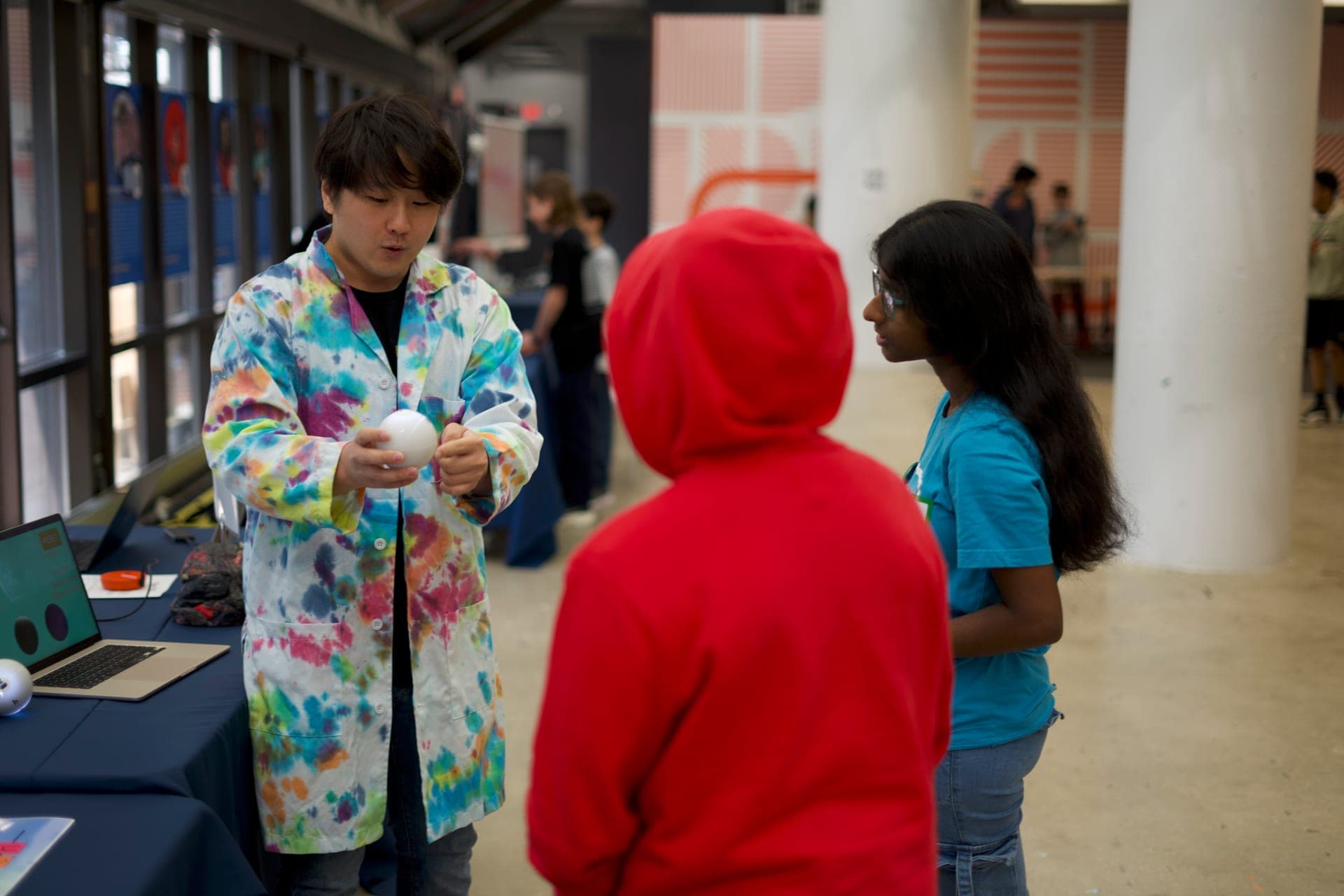 A child fascinated by a glowing Qubi at the KID Museum quantum booth