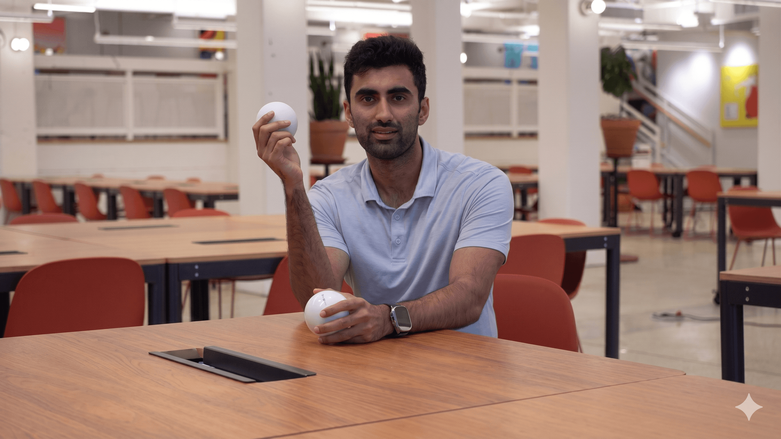 An instructor holding two Qubi spheres, ready to teach quantum